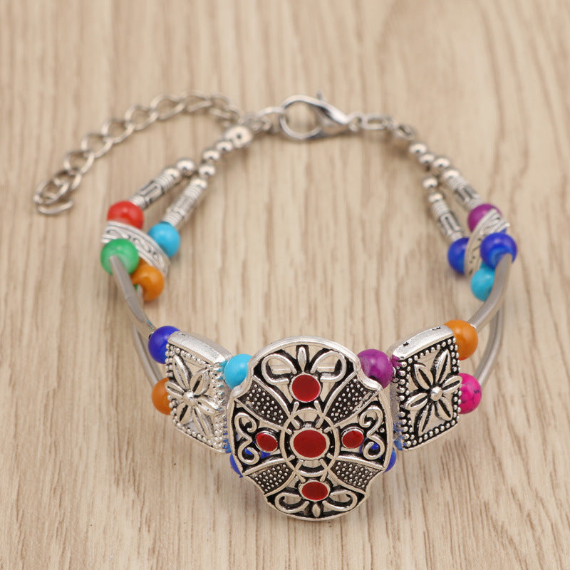 Pulseira de metal com miçangas florais coloridas